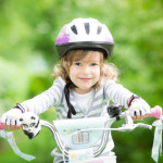 Happy kid sitting on the bike