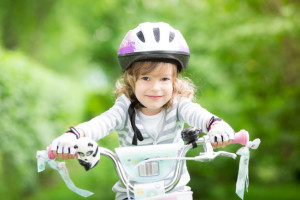 Happy kid sitting on the bike