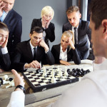 Business people playing chess