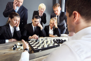 Business people playing chess