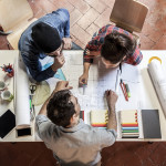 Teamwork. Three young architects working on a project