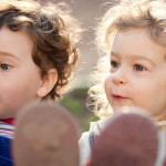 Sisters playing on swings