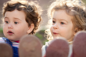 Sisters playing on swings