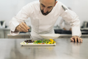 Male professional chef cooking in a kitchen.