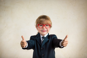 Portrait of young happy businessman showing thumbs up. Success and creative concept. Copy space for your text